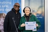 A picture of Barbara Augun and Mayor Derrick L. Henry posing with her Health Habits Commitment Award. 